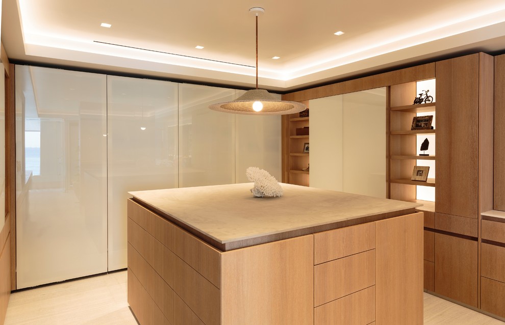 Photo of a large contemporary gender-neutral walk-in wardrobe in Los Angeles with flat-panel cabinets, medium wood cabinets, light hardwood floors and beige floor.