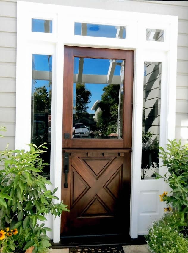 This is an example of a mid-sized transitional front door in Orange County with grey walls, a dutch front door, beige floor and a dark wood front door.