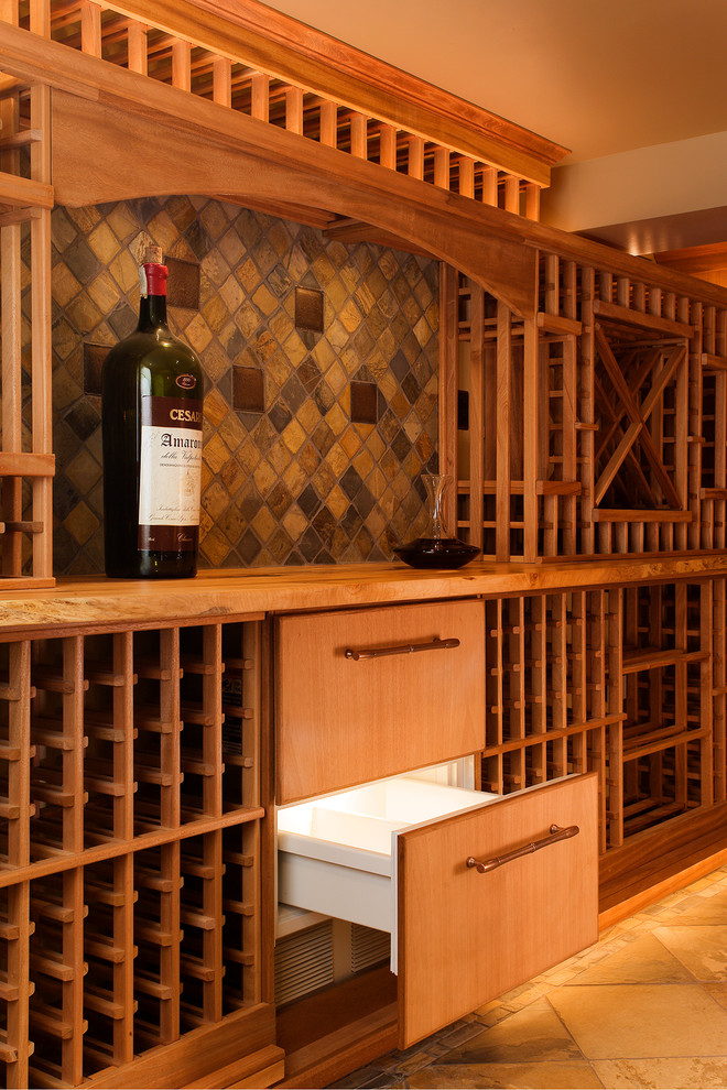 Photo of a mid-sized country wine cellar in Seattle with travertine floors and storage racks.