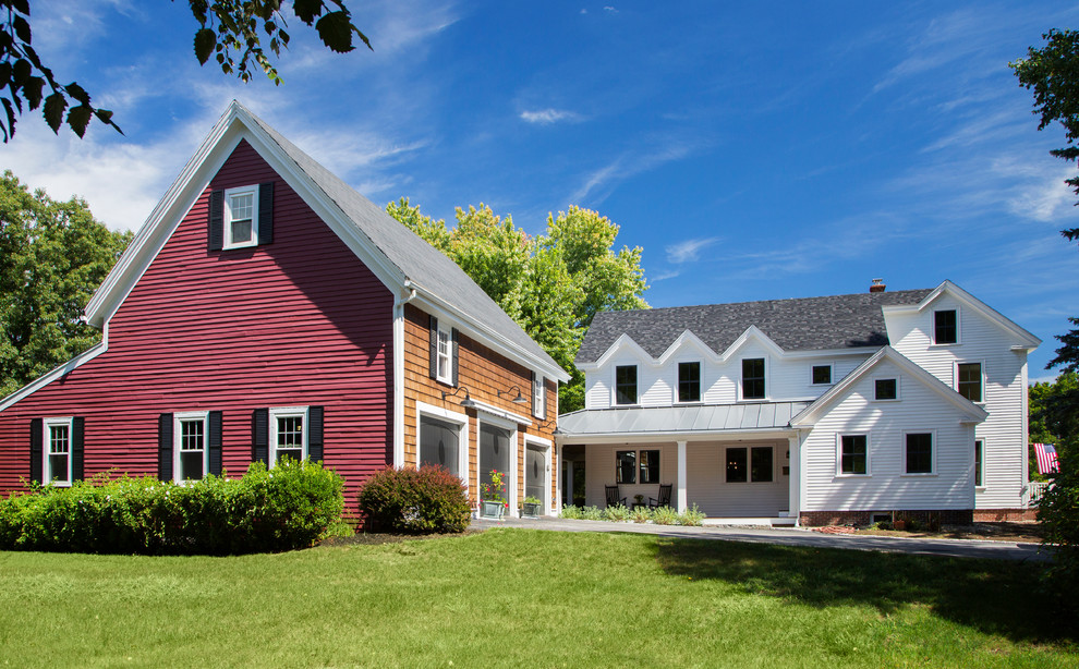 Photo of a large country two-storey white exterior in Boston with wood siding and a gable roof.