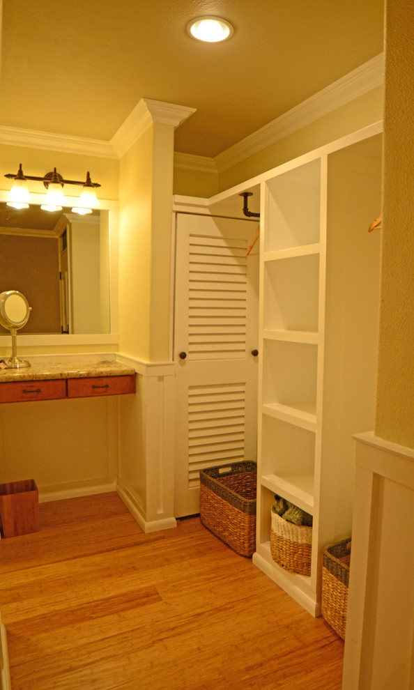 Design ideas for a mid-sized traditional gender-neutral dressing room in Hawaii with open cabinets, white cabinets and bamboo floors.