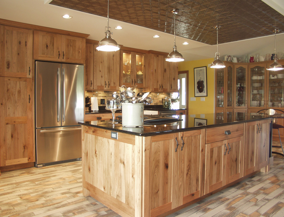 Kitchen - rustic kitchen idea with flat-panel cabinets, light wood cabinets, granite countertops, stainless steel appliances and an island