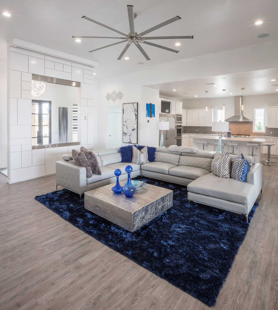 Expansive transitional formal open concept living room in Other with white walls and vinyl floors.