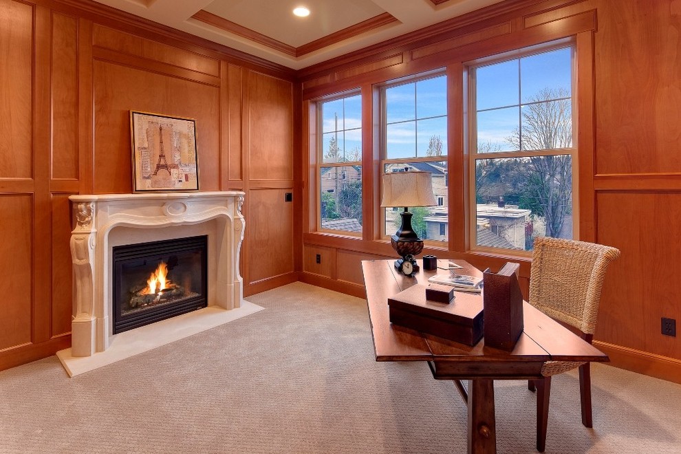 This is an example of a mid-sized contemporary home office in Newark with carpet, a standard fireplace, a stone fireplace surround and a freestanding desk.
