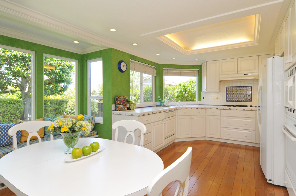 Photo of a traditional kitchen in San Francisco with tile benchtops and white appliances.