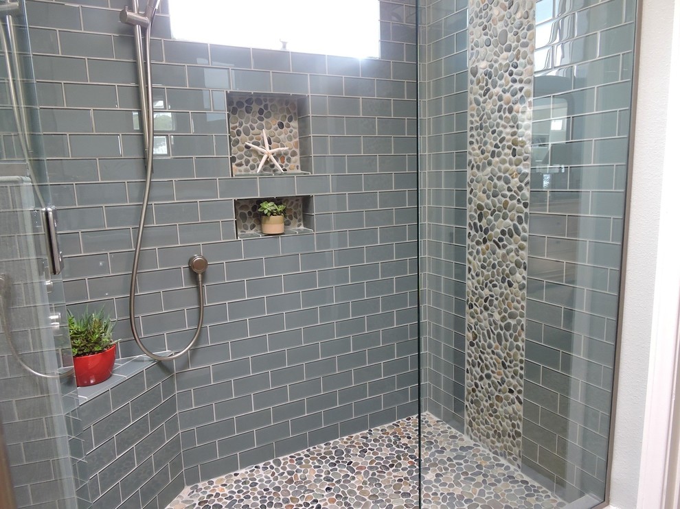 Design ideas for a mid-sized beach style master bathroom in New York with a corner shower, gray tile, subway tile, grey walls and pebble tile floors.