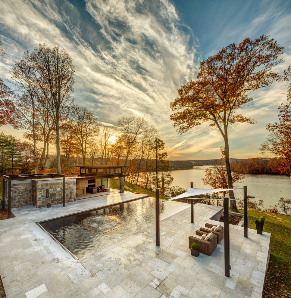 Design ideas for a large traditional backyard rectangular infinity pool in New York with a hot tub and tile.