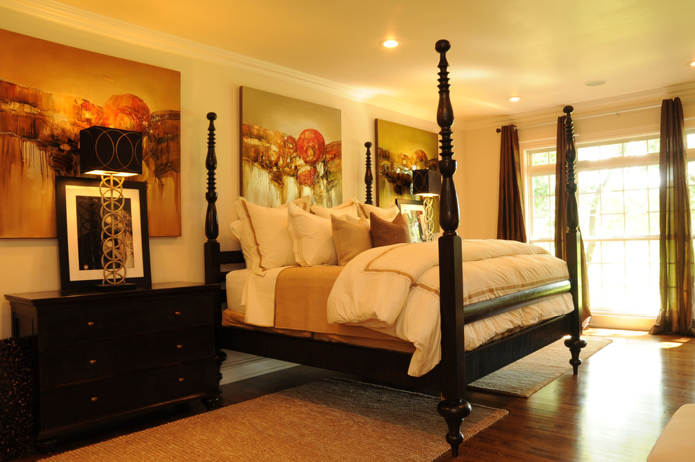 Traditional bedroom with beige walls and medium hardwood floors.