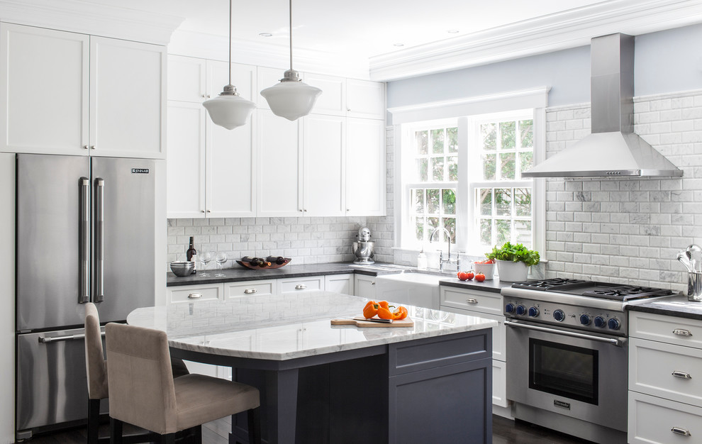 Inspiration for a mid-sized traditional u-shaped eat-in kitchen in Boston with a farmhouse sink, recessed-panel cabinets, white cabinets, granite benchtops, grey splashback, stainless steel appliances, dark hardwood floors and with island.