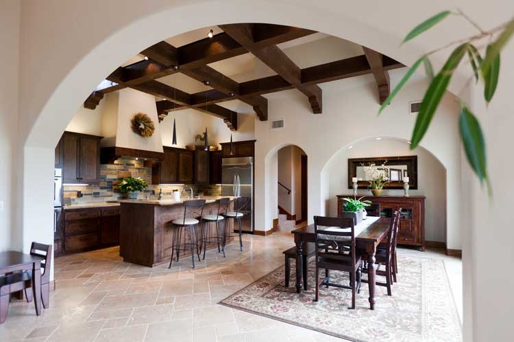 Design ideas for a mid-sized mediterranean single-wall eat-in kitchen in San Luis Obispo with an undermount sink, recessed-panel cabinets, medium wood cabinets, granite benchtops, multi-coloured splashback, stone tile splashback, stainless steel appliances, travertine floors and with island.