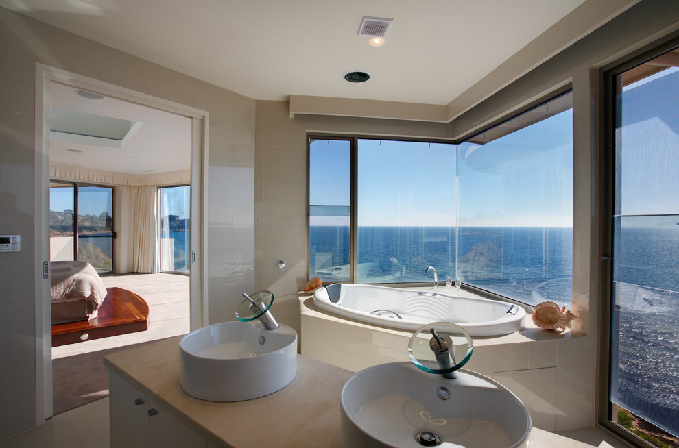 Photo of a mid-sized beach style master bathroom in Melbourne with a hot tub.