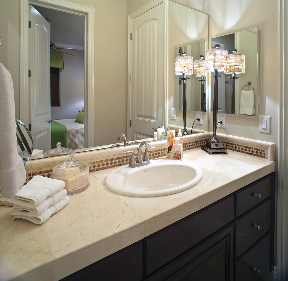 This is an example of a contemporary bathroom in Nashville with tile benchtops.