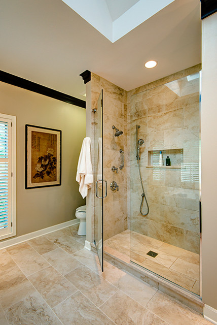 This is an example of a large eclectic master bathroom in Chicago with an integrated sink, flat-panel cabinets, dark wood cabinets, marble benchtops, an undermount tub, an alcove shower, a two-piece toilet, beige tile, ceramic tile, beige walls and ceramic floors.