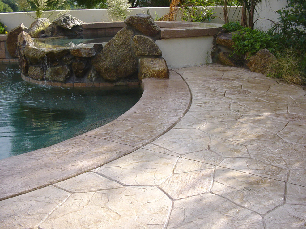 Mid-sized traditional backyard aboveground pool in Phoenix with stamped concrete.