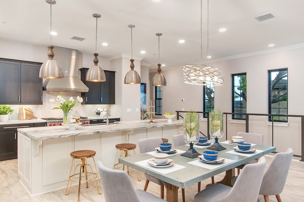 Photo of a transitional kitchen/dining combo in San Diego with beige walls and light hardwood floors.
