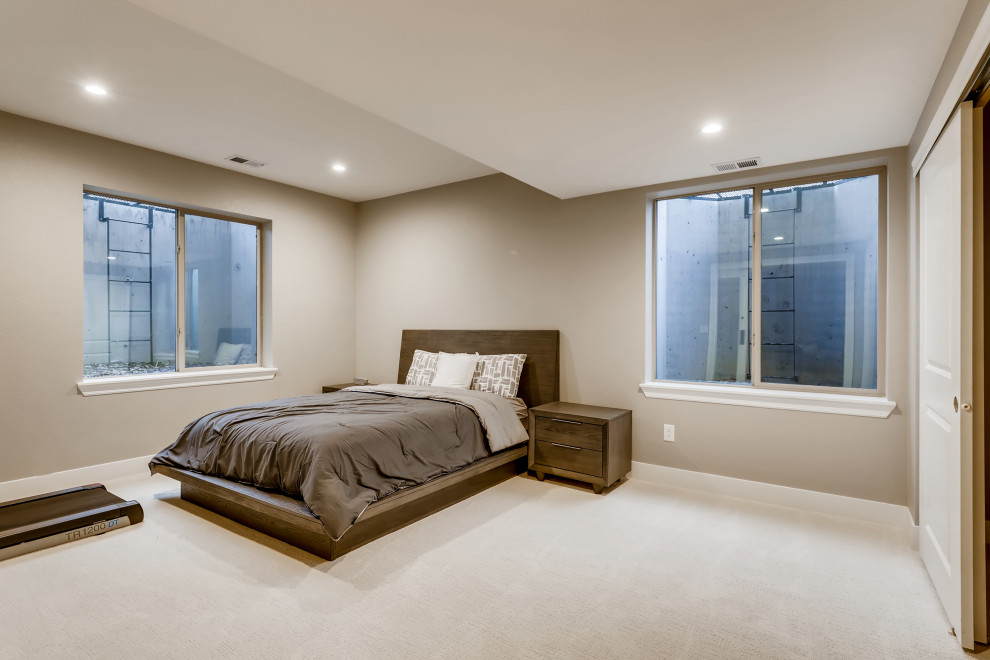 Photo of a mid-sized modern guest bedroom in Denver with grey walls, carpet, white floor and wallpaper.