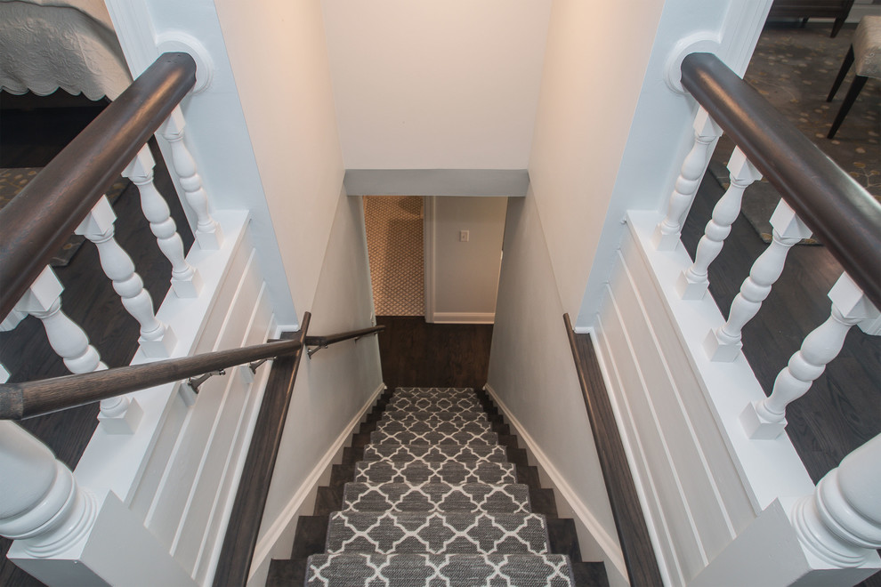 Inspiration for a mid-sized beach style carpeted straight staircase in Milwaukee with carpet risers and wood railing.