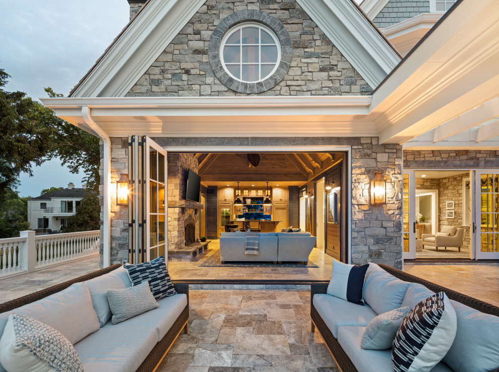 Inspiration for a timeless backyard stone patio remodel in Minneapolis with a fireplace and a pergola
