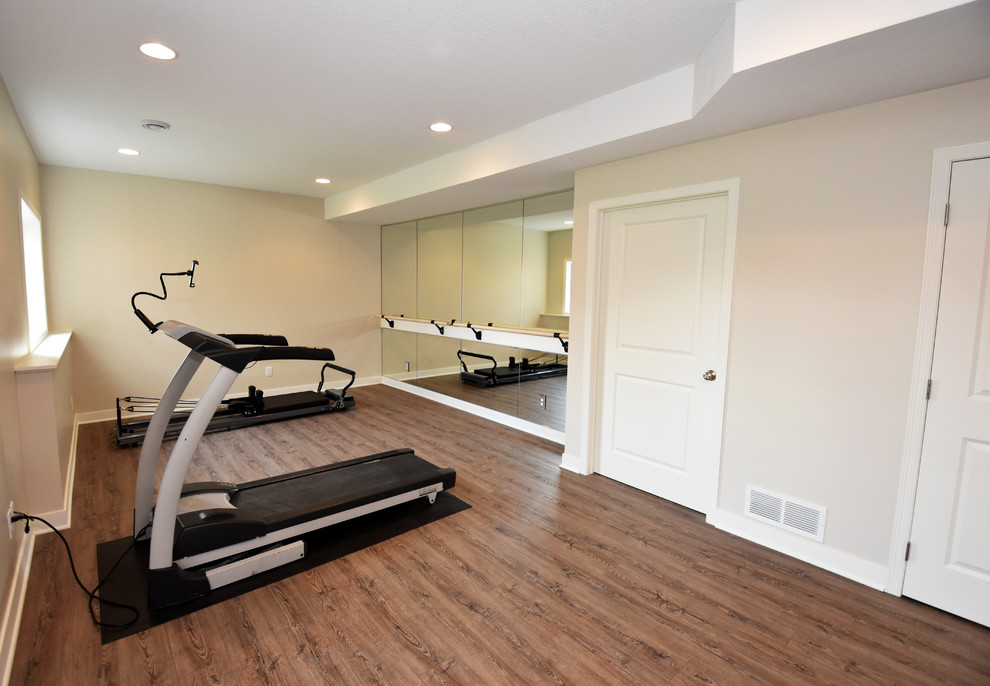 Design ideas for a large contemporary multipurpose gym in Minneapolis with beige walls, vinyl floors and brown floor.