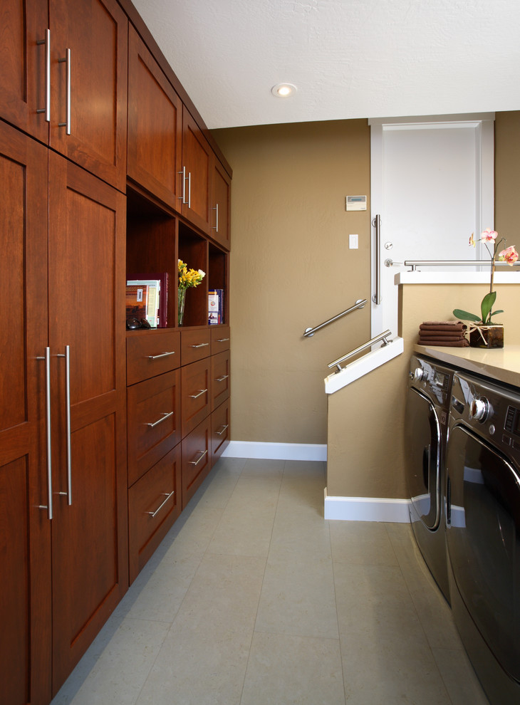 Photo of a transitional laundry room in San Francisco with beige walls and grey floor.