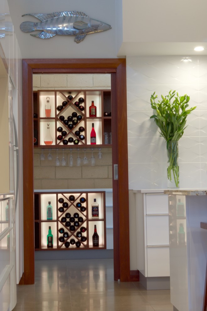 Large modern galley kitchen pantry in Adelaide with an undermount sink, flat-panel cabinets, white cabinets, quartz benchtops, white splashback, ceramic splashback, stainless steel appliances, ceramic floors and with island.