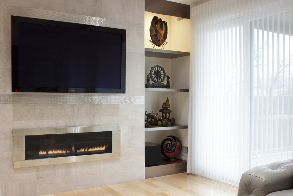 Photo of a large asian open concept living room in New York with beige walls, light hardwood floors, a ribbon fireplace, a tile fireplace surround and a wall-mounted tv.
