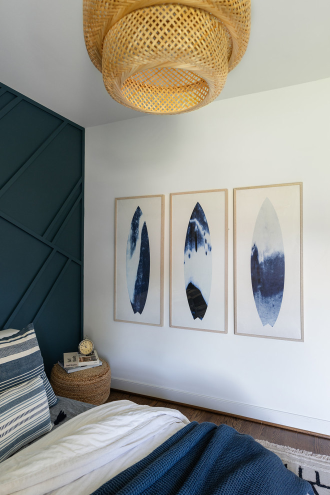 This is an example of a mid-sized beach style kids' bedroom for kids 4-10 years old and boys in Richmond with blue walls, medium hardwood floors and panelled walls.