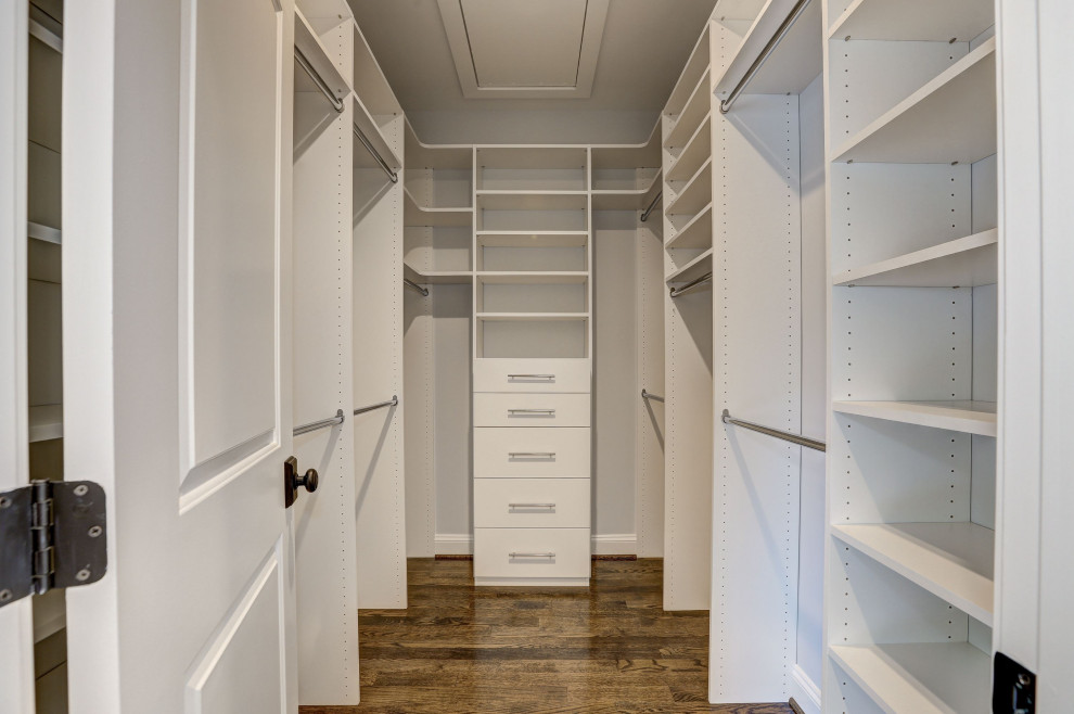 Inspiration for a country walk-in wardrobe in DC Metro with dark hardwood floors.