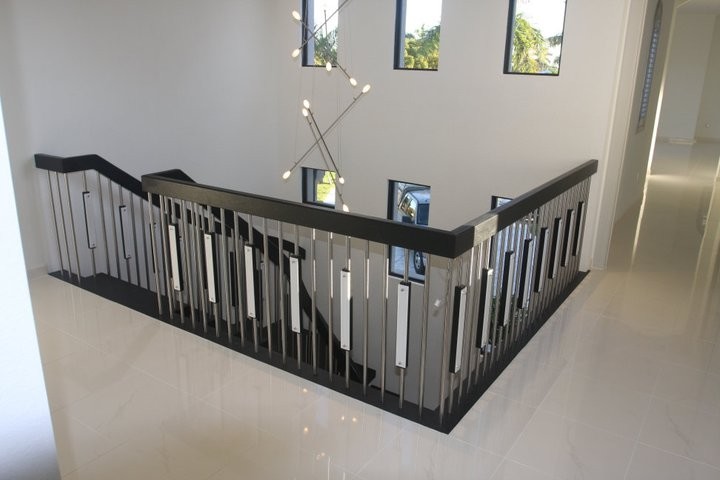 This is an example of a contemporary wood staircase in Other with open risers.
