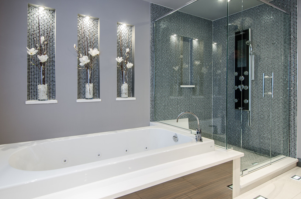Transitional master bathroom in Ottawa with an alcove tub, a corner shower, blue tile and grey walls.