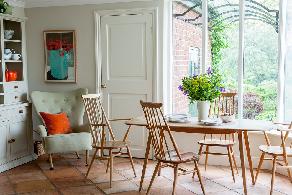 Inspiration for a traditional dining room in Other with terra-cotta floors.