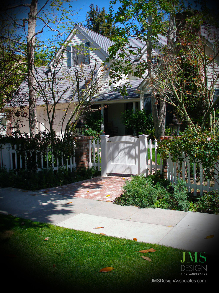 Photo of a small traditional one-storey white exterior in Los Angeles with wood siding.