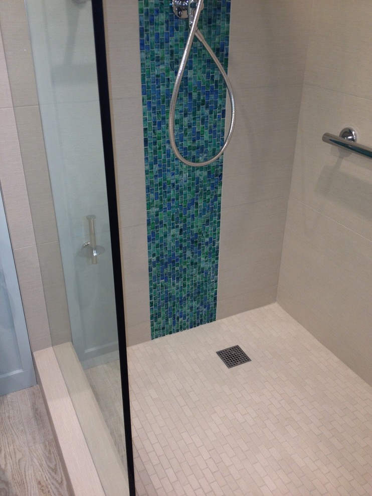 Design ideas for a mid-sized transitional master bathroom in Hawaii with an integrated sink, flat-panel cabinets, dark wood cabinets, solid surface benchtops, an open shower, blue tile, glass tile, blue walls and porcelain floors.