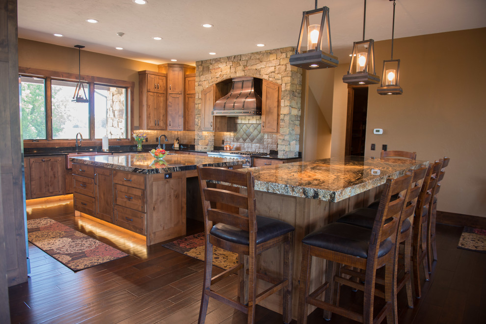 Inspiration for a huge rustic u-shaped medium tone wood floor eat-in kitchen remodel with a double-bowl sink, shaker cabinets, medium tone wood cabinets, granite countertops, metallic backsplash, stainless steel appliances and two islands