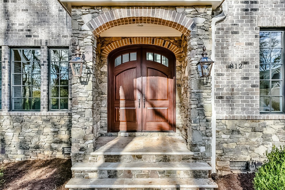 Inspiration for a huge transitional two-story mixed siding house exterior remodel in Charlotte with a clipped gable roof and a shingle roof