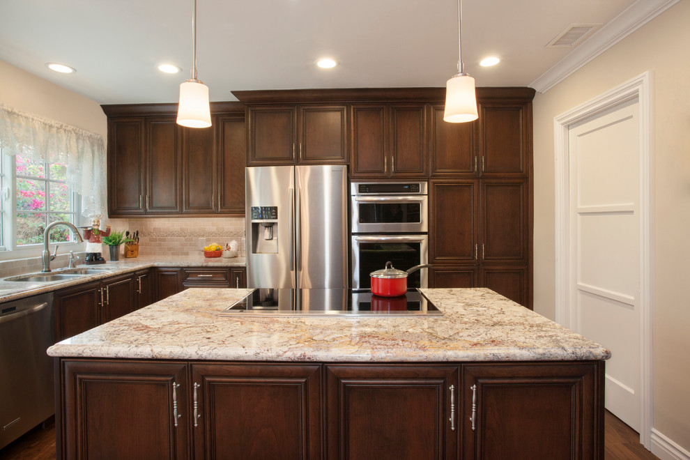 Design ideas for a transitional kitchen in Los Angeles with granite benchtops, beige splashback and with island.