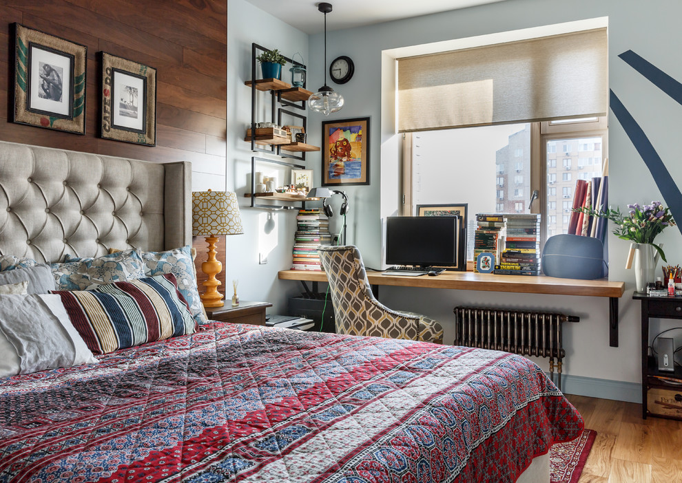 Inspiration for an eclectic master bedroom in Moscow with medium hardwood floors and brown floor.