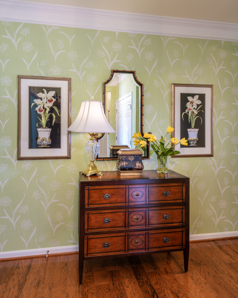 This is an example of a traditional foyer in Richmond with green walls, brown floor and wallpaper.