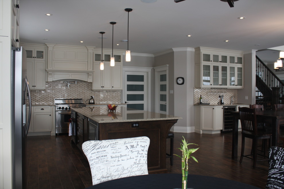 Inspiration for a large timeless l-shaped medium tone wood floor eat-in kitchen remodel with an island, recessed-panel cabinets, yellow cabinets, quartz countertops, black backsplash, cement tile backsplash, stainless steel appliances and a farmhouse sink