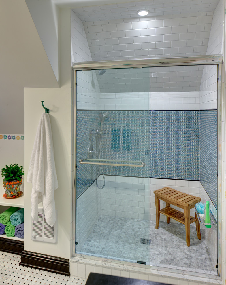 Inspiration for a mid-sized eclectic kids bathroom in New York with an integrated sink, furniture-like cabinets, white cabinets, a double shower, a two-piece toilet, multi-coloured tile, ceramic tile, white walls and mosaic tile floors.