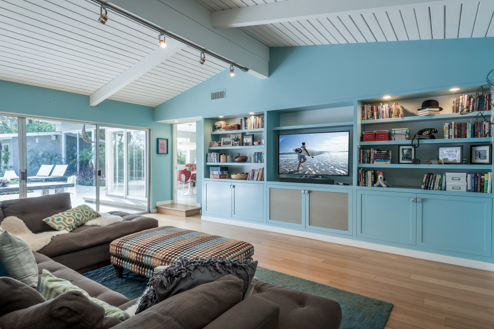 This is an example of a transitional open concept family room in Los Angeles with blue walls, medium hardwood floors, no fireplace, a freestanding tv, brown floor, timber and vaulted.