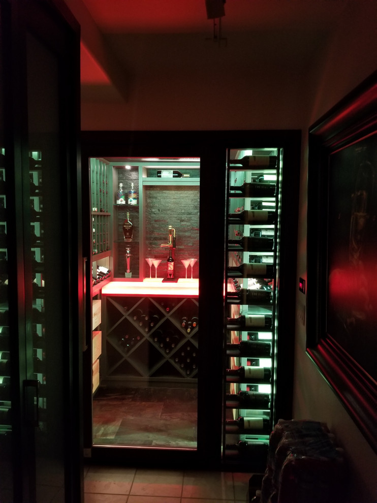 Mid-sized transitional wine cellar photo in Orange County with storage racks