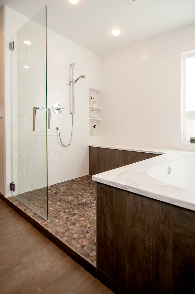 Inspiration for a large transitional master bathroom in Seattle with shaker cabinets, dark wood cabinets, an undermount tub, an open shower, multi-coloured tile, pebble tile, white walls, porcelain floors, an undermount sink and marble benchtops.