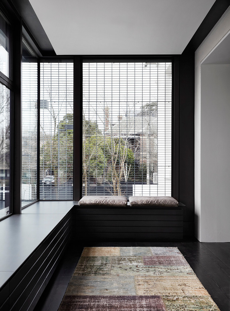 Inspiration for a contemporary hallway in Melbourne with black floor.