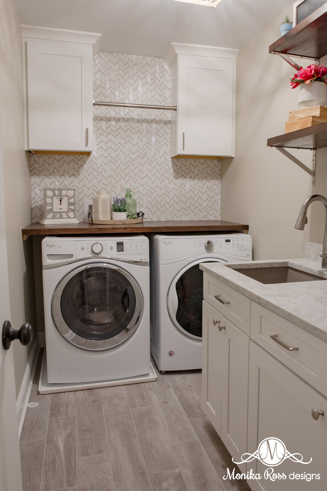 Design ideas for a small transitional u-shaped dedicated laundry room in Chicago with an undermount sink, shaker cabinets, white cabinets, quartz benchtops, beige walls, porcelain floors, a side-by-side washer and dryer, grey floor and beige benchtop.
