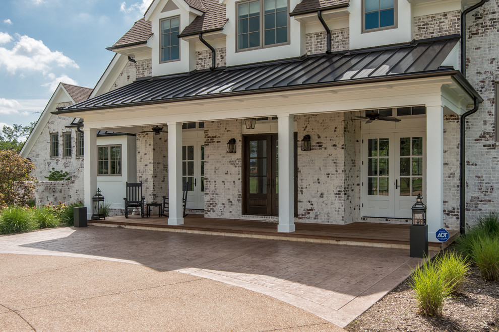 Inspiration for a transitional white two-story house exterior remodel in Nashville with a mixed material roof