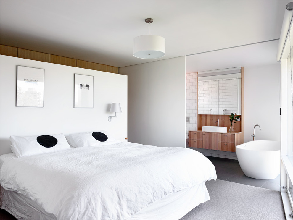 Contemporary master bedroom in Hobart with white walls.