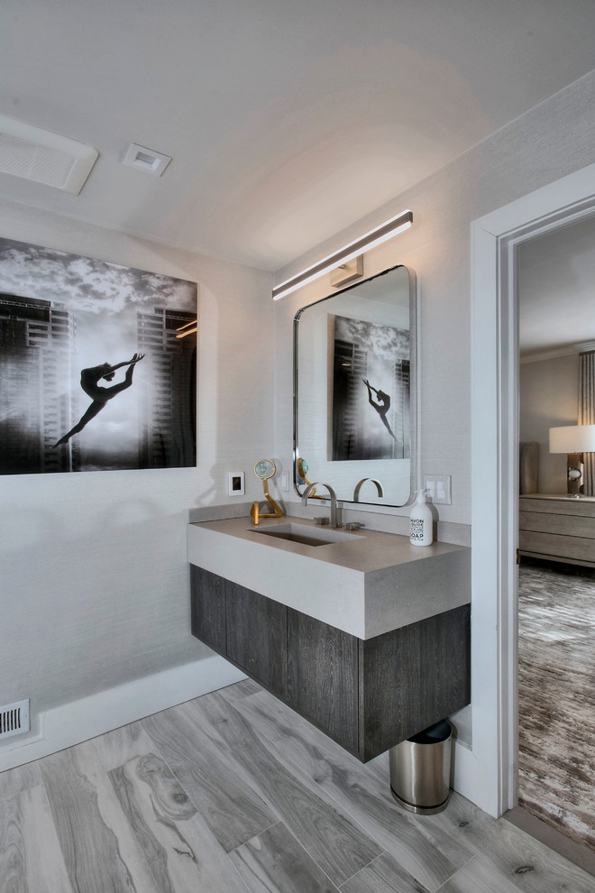 Example of a mid-sized transitional gray tile and porcelain tile porcelain tile and gray floor double shower design in New York with gray cabinets, a one-piece toilet, gray walls, a wall-mount sink, quartz countertops, gray countertops and a hinged shower door