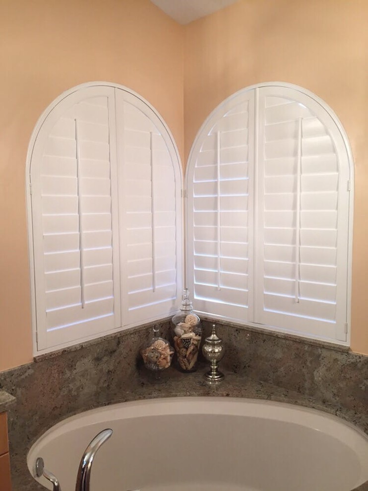 Example of a mid-sized transitional master corner bathtub design in Orange County with beige walls