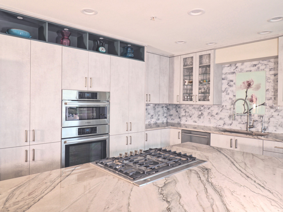 Mid-sized contemporary l-shaped open plan kitchen in Tampa with a single-bowl sink, flat-panel cabinets, grey cabinets, quartzite benchtops, grey splashback, glass tile splashback, stainless steel appliances, vinyl floors, with island, grey floor, green benchtop and coffered.